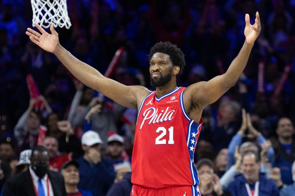 76ers center Joel Embiid turns to the crowd after a score.