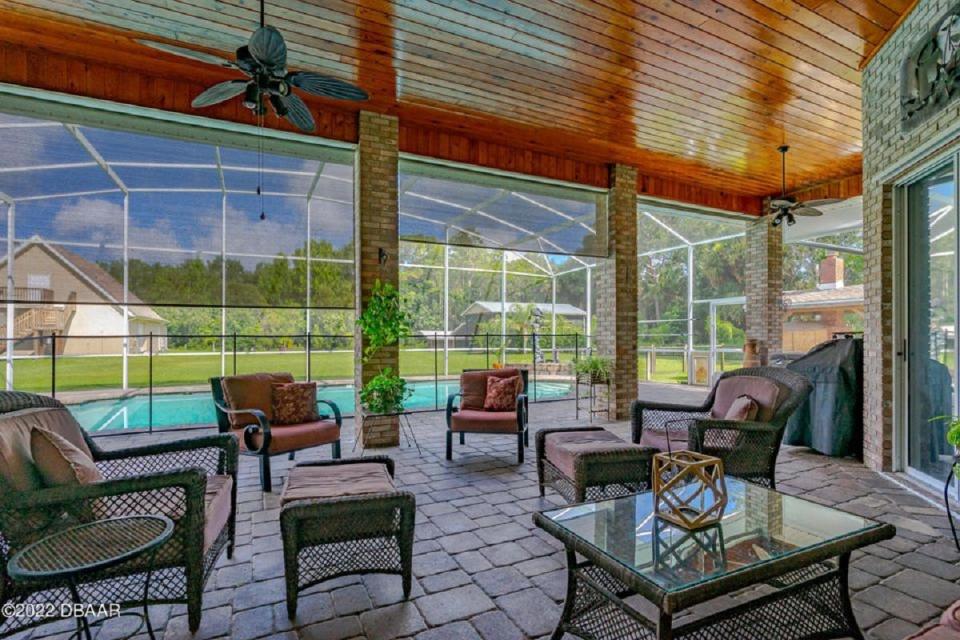 Pavers cover the screened-in lanai and surround the sparkling pool of this beautiful estate, nestled in an incredibly safe and private subdivision that is very family friendly and has no HOA.