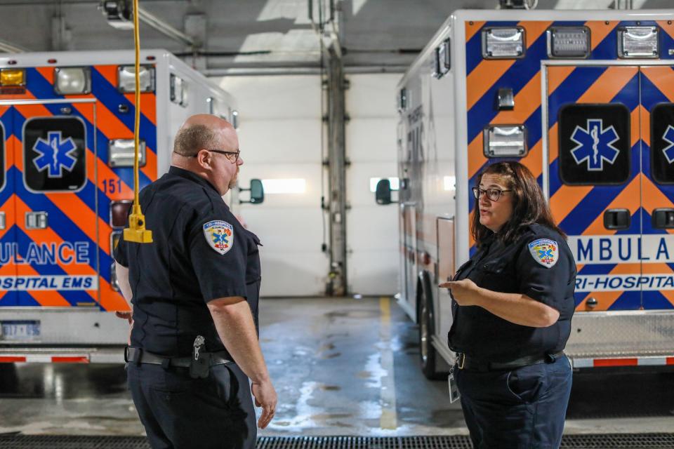 Paramedic Bill Adams, 46, talks with Operations Manager Trish May, 50, about logistics in the ambulance garage at Tri-Hospital EMS in Port Huron.