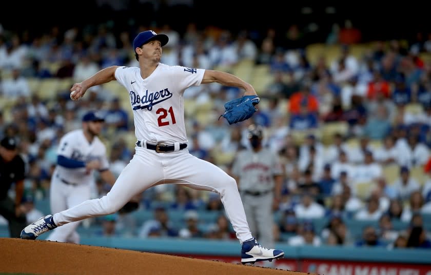 LOS ANGELES, CALIF. - AUG. 3, 2021. Dodgers starter Walker Buehler delivers a pitch against the Astros in the first inning at Dodger Stadium on Tuesday, Aug. 3, 2021. The Astros cheated by stealing signals during the 2017 World Series against Dodgers. (Luis Sinco / Los Angeles Times)