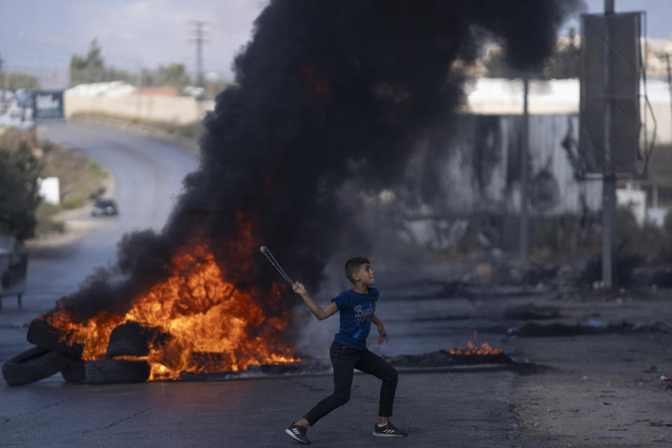 Palestinian demonstrators clash with Israeli forces following a demonstration in support of the Gaza Strip, in the West Bank city of Ramallah, Friday, Oct. 13, 2023. Tens of thousands of Muslims demonstrated Friday across the Middle East in support of the Palestinians and against the intensifying Israeli bombardment of Gaza, underscoring the risk of a wider regional conflict as Israel prepares for a possible ground invasion. (AP Photo/Nasser Nasser)