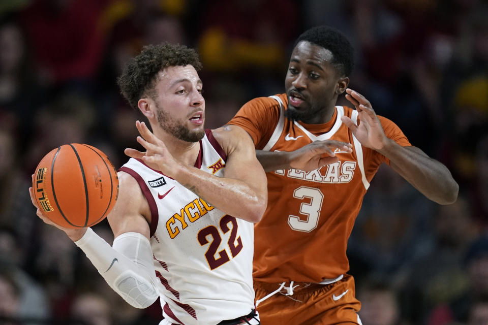 Iowa State guard Gabe Kalscheur (22) passes ahead of Texas guard Courtney Ramey (3) during the second half of an NCAA college basketball game, Saturday, Jan. 15, 2022, in Ames, Iowa. Iowa State won 79-70. (AP Photo/Charlie Neibergall)