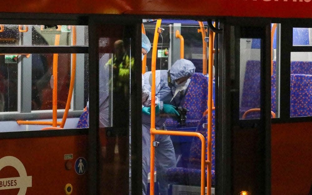 Forensic officers analyse the double-decker bus on board which three people were stabbed - UK News In Pictures (UKNIP)