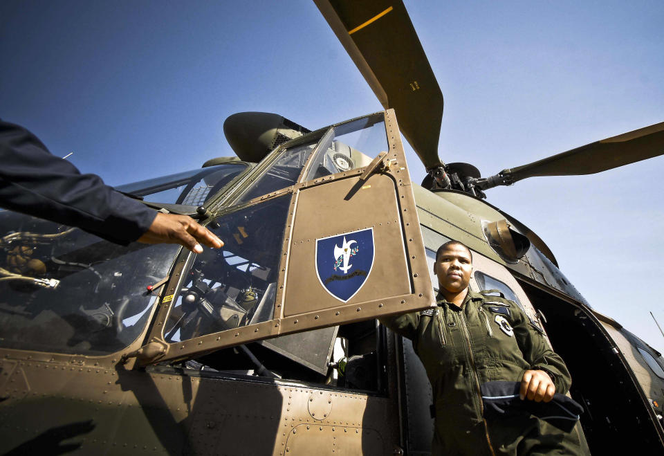 Phetogo Molawa, a 21-year-old air force lieutenant stands next to the big Oryx Air Force transport helicopter at the third Women's Conference in Defence in Canturion, South Africa. Molawa is&nbsp;South Africa's first black female pilot.