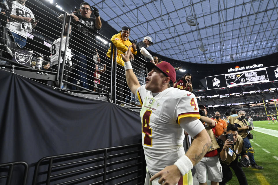 Washington Football Team quarterback Taylor Heinicke (4) celebrates after the Washington Football Team defeated the Las Vegas Raiders in an NFL football game, Sunday, Dec. 5, 2021, in Las Vegas. (AP Photo/David Becker)