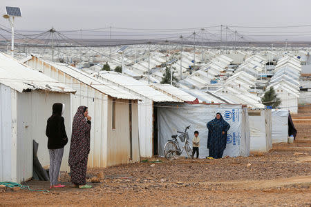 FILE PHOTO: Syrian refugee women stand in front of their homes at Azraq refugee camp, near Al Azraq city, Jordan, December 8, 2018. REUTERS/Muhammad Ham