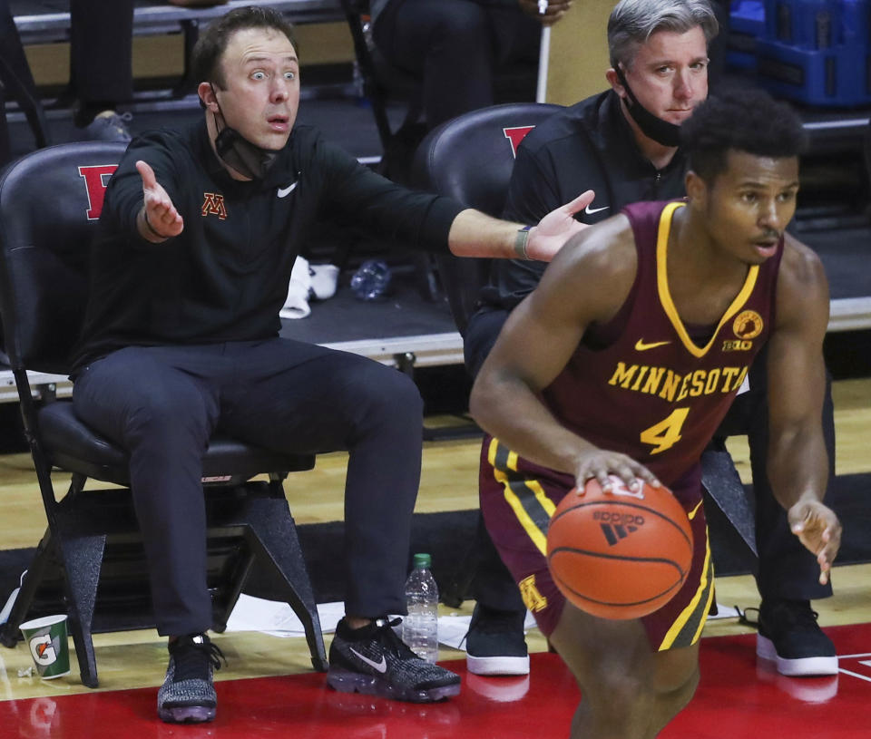 Minnesota coach Richard Pitino, left, gestures dduring the second half of the team's NCAA college basketball game against Rutgers on Thursday, Feb. 4, 2021, in Piscataway, N.J. (Andrew Mills/NJ Advance Media via AP)