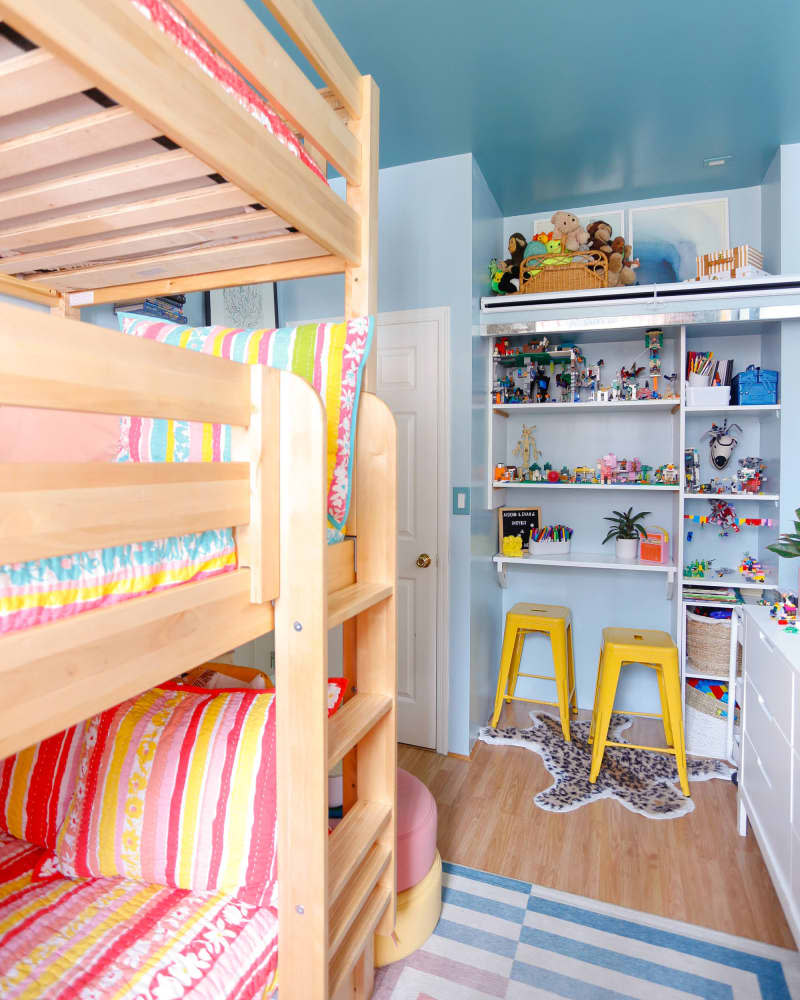 Blue kids bedroom with wood bunk beds and colorful accents