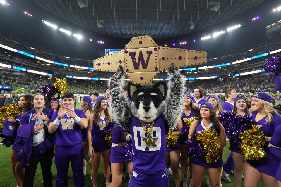 Dec. 1, 2023; Las Vegas, Nevada; Washington Huskies mascot Harry the Husky and cheerleaders pose after the Pac-12 Championship game against the Oregon Ducks at Allegiant Stadium. Kirby Lee-USA TODAY Sports