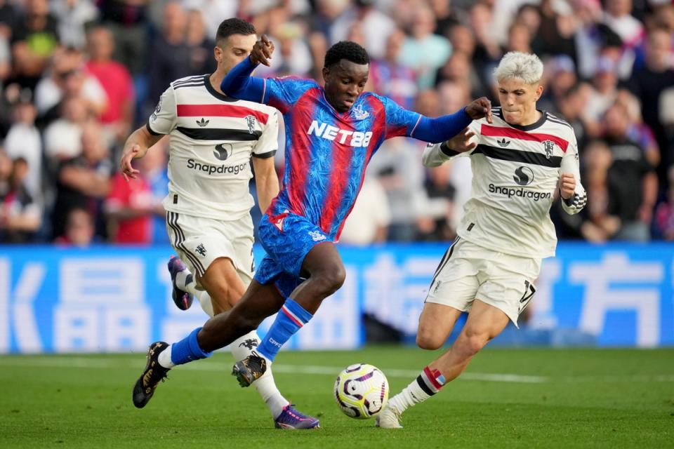 Nketiah takes on Manchester United defenders at Selhurst Park (AP)