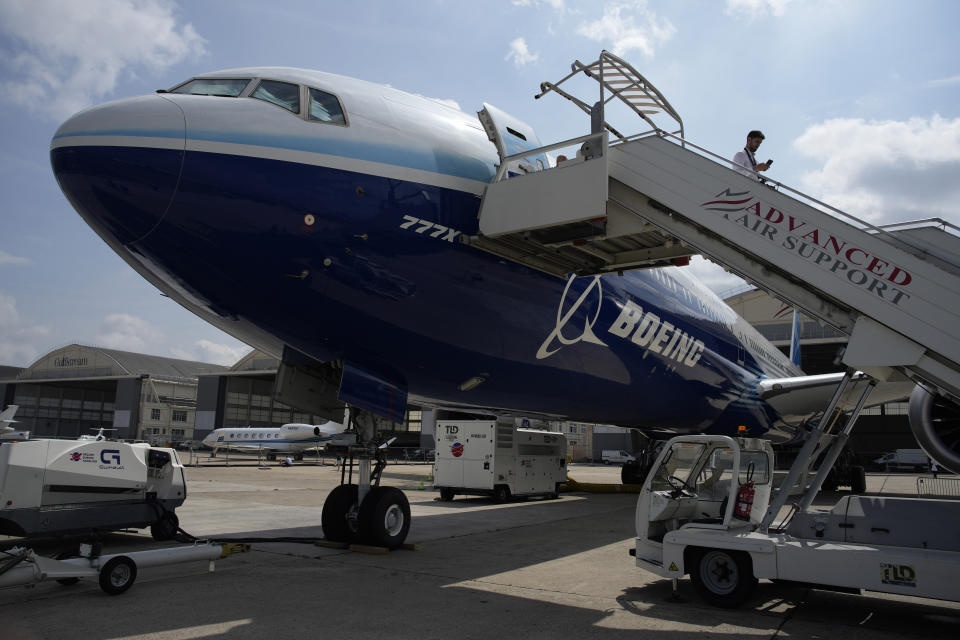 FILE - A man walks down the steps of the Boeing 777X airplane during the Paris Air Show in Le Bourget, north of Paris, France, Monday, June 19, 2023. Airlines are facing increasing pressure to cut their climate-changing emissions. That made sustainable aviation fuel a hot topic this week at the Paris Air Show, a major industry event. Sustainable fuel made from food waste or plant material is aviation's best hope for reducing emissions in the next couple of decades. (AP Photo/Lewis Joly, File)