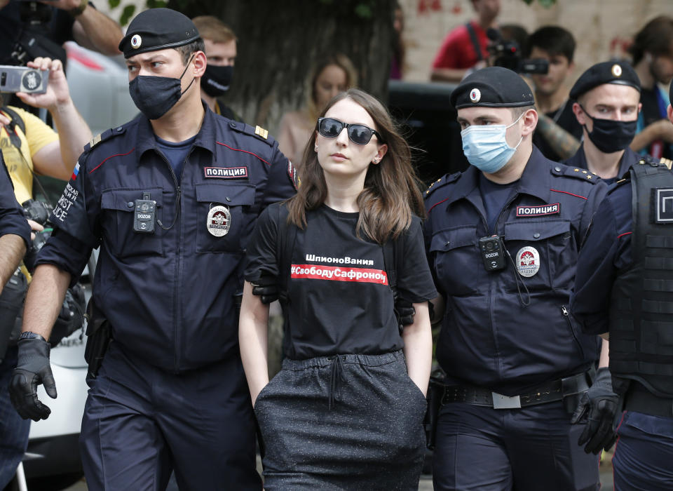 Police officers detain Taisiya Bekbulatova, chief editor of the Kholod Internet magazine wearing a T-shirt with a slogan that reads: "Freedom to Safronov", during a rally to support Ivan Safronov near the Lefortovo prison in Moscow, Russia, Monday, July 13, 2020. Safronov, an ex-journalist who worked as an adviser to the director of Russia's state space corporation has been arrested and jailed on charges of passing military secrets to Czech intelligence. Ivan Safronov wrote about military and security issues before becoming an adviser to the head of Roscosmos. (AP Photo/Alexander Zemlianichenko)