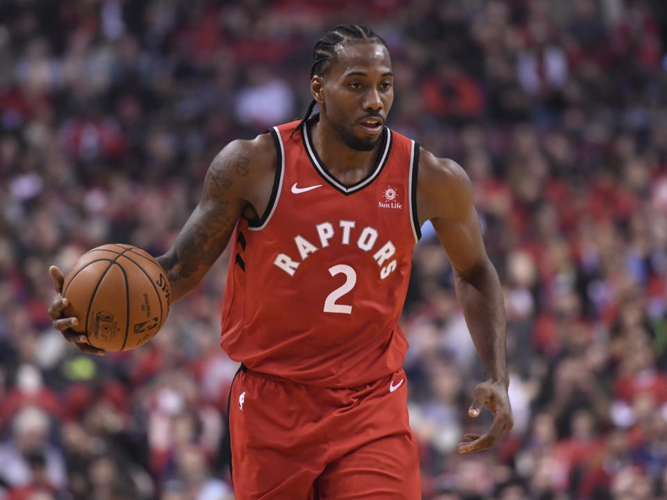 Toronto Raptors forward Kawhi Leonard (2) takes the ball up court against the Cleveland Cavaliers during first half NBA basketball action in Toronto on Wednesday, Oct. 17, 2018. (Nathan Denette/The Canadian Press via AP)