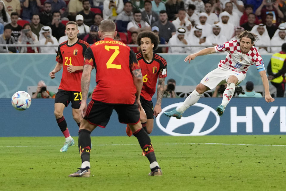 Croatia's Luka Modric, right, intends to score a goal during the World Cup group F soccer match between Croatia and Belgium at the Ahmad Bin Ali Stadium in Al Rayyan, Qatar, Thursday, Dec. 1, 2022. (AP Photo/Thanassis Stavrakis)