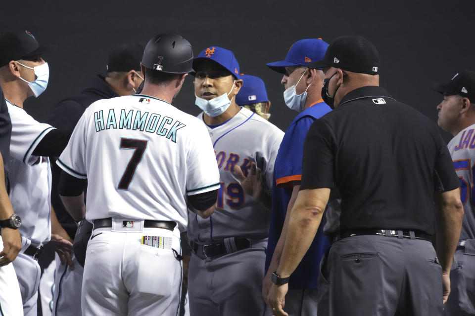 Arizona Diamondbacks coach Robby Hammock (7) and New York Mets manager Luis Rojas (19) talk after benches cleared during the fifth inning of a baseball game Tuesday, June 1, 2021, in Phoenix. (AP Photo/Rick Scuteri)