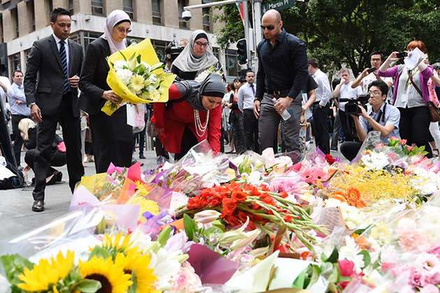 Members of the Muslim community lay flowers at the shrine on Martin Place. Photo: AAP