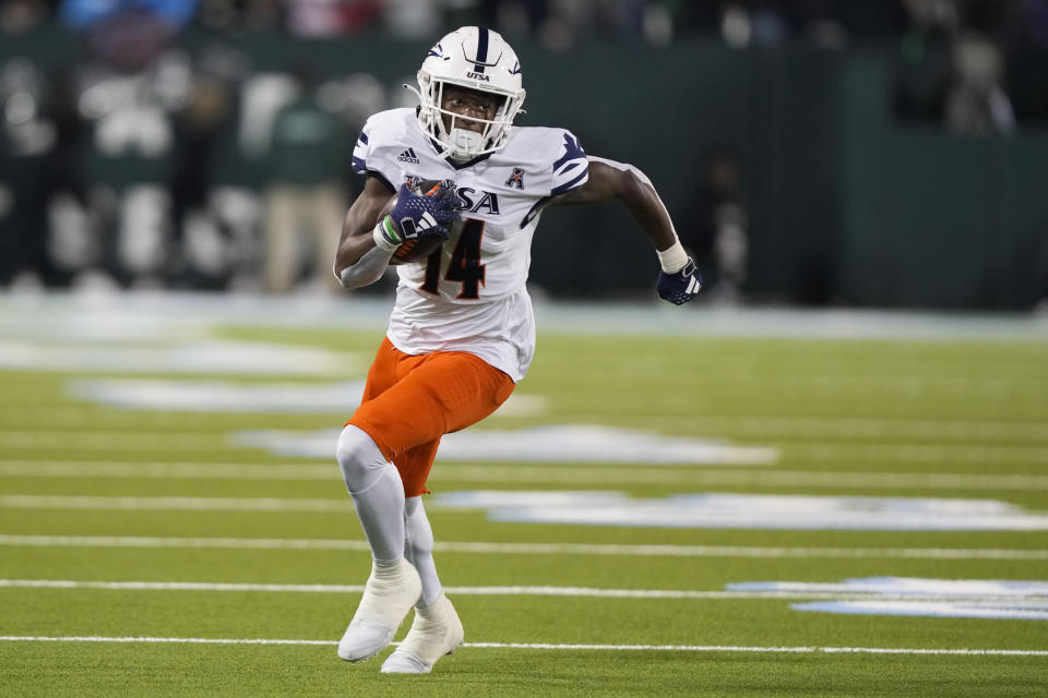 UTSA wide receiver Devin McCuin (14) carries in the second half of an NCAA college football game against Tulane in New Orleans, Friday, Nov. 24, 2023. Tulane won 29-16. (AP Photo/Gerald Herbert)