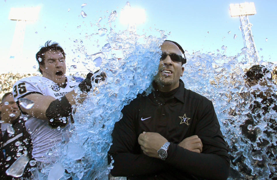 FILE - In this Saturday, Jan. 4, 2014 file photo, Vanderbilt coach James Franklin is doused by linebacker Chase Garnham (36) after they defeated Houston 41-24 in the BBVA Compass Bowl NCAA college football game in Birmingham, Ala. "We’re making tremendous strides," Franklin says. "The more opportunities that coaches get and go out and do well and succeed, it helps. It helps change perceptions, and perceptions are a powerful thing." (AP Photo/Butch Dill)