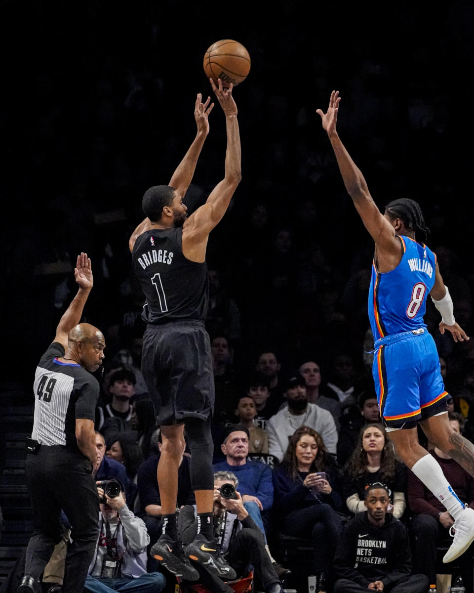 Brooklyn Nets forward Mikal Bridges (1) shoots over Oklahoma City Thunder forward Jalen Williams (8) during the first half of an NBA basketball game in New York, Friday, Jan. 5, 2024. (AP Photo/Peter K. Afriyie)