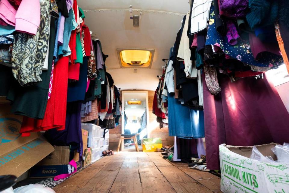 One of the CleanUP buses was converted to a clothing shop with individual sides for men and women’s clothing Tuesday, Aug. 9, 2022, in Fort Worth. CleanUP hosts events throughout the area to offer free haircuts and clothing.