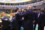 French President Emmanuel Macron, left, speaks with Bulgarian Prime Minister Boyko Borissov, center right, during a round table meeting at an EU summit in Brussels, Thursday, Feb. 20, 2020. After almost two years of sparring, the EU will be discussing the bloc's budget to work out Europe's spending plans for the next seven years. (AP Photo/Olivier Matthys)