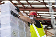 In this photo provided by the New Zealand Defense Force, Air Movements personnel stack and secure pallets of disaster relief supplies at an airbase in Auckland, New Zealand, Monday, Jan. 17, 2022, to be sent to Tonga in the wake of a Tsunami triggered by volcanic eruption. Thick ash on an airport runway was delaying aid deliveries to the Pacific island nation of Tonga, where significant damage was being reported days after a huge undersea volcanic eruption and tsunami. (Dillon Robert Anderson/NZDF via AP)