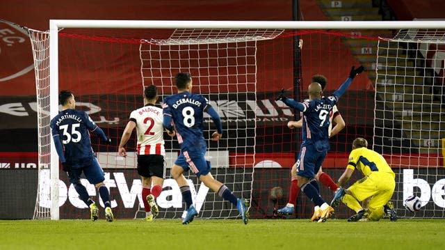 Gabriel Martinelli, left, taps in the second goal