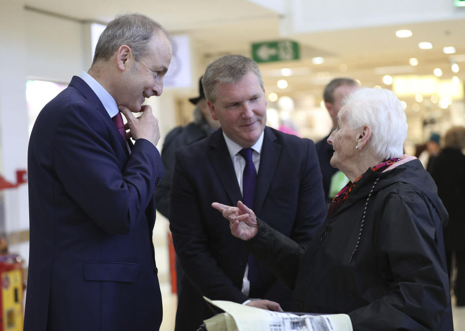 Fianna Fail leader Micheal Martin, left, and Fianna Fail spokesperson for finance, Michael McGrath, center, meets shoppers at a shopping center in Cork, Ireland, Friday Feb. 7, 2020, on the last day of campaigning ahead of the general election. Irish voters will choose a new parliament on Saturday, and may have bad news for the two parties that have dominated the country’s politics for a century, Fianna Fail and Fine Gael. Polls show a surprise surge for Sinn Fein, the party historically linked to the Irish Republican Army and its violent struggle for a united Ireland. (Yui Mok/PA via AP)