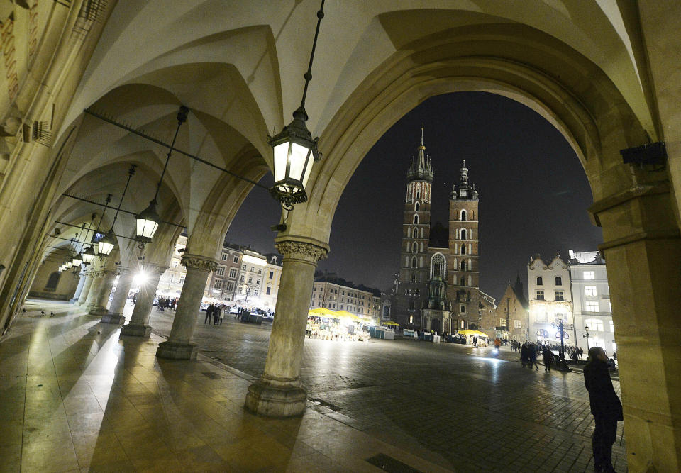 FILE - In this file photo taken on March 30, 2019, St. Mary's Basilica in the market square in Krakow, Poland. Every hour, a trumpeter plays the city's trademark bugle call from the taller tower. Officials said Thursday, May 6, 2021, that the team of trumpeters, who are retired firefighters, was recently reinforced with two new players.(AP Photo/Czarek Sokolowski)