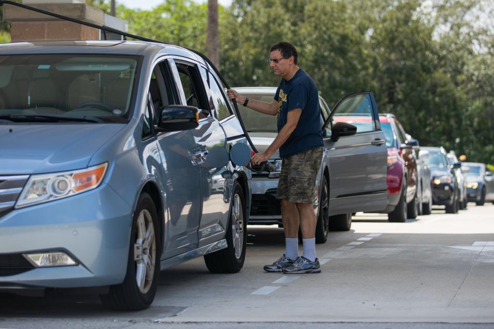 Justin Rosenthal, of Boca Raton, pumps gas into his mini-van at a Costco gas station on Friday, September 23, 2022, in Boca Raton, FL. "I'm a former boy scout, I like to be prepared," Rosenthal said, referring to readiness ahead of the potential hurricane threat of Tropical Depression Nine in the Caribbean Sea.