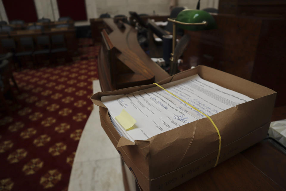 A petition to put abortion access on the ballot in West Virginia sits in the empty House of Delegates chamber on June 21, 2024, at the State Capitol in Charleston, W.Va. Submitted by the minority Democrats during a special session of the state Legislature in May, the petition was sent to the Health and Human Resources Committee for consideration. Republican leadership declined to take the matter up. (AP Photo/Leah Willingham)