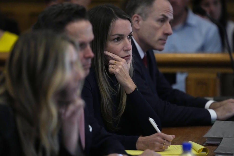 Karen Read, second from right, listens to testimony by witness Nicole Albert during Read's trial at Norfolk County Superior Court, Friday, May 10, 2024, in Dedham, Mass. Read, 44, is accused of running into her Boston police officer boyfriend with her SUV in the middle of a nor'easter and leaving him for dead after a night of heavy drinking. (AP Photo/Charles Krupa, Pool)