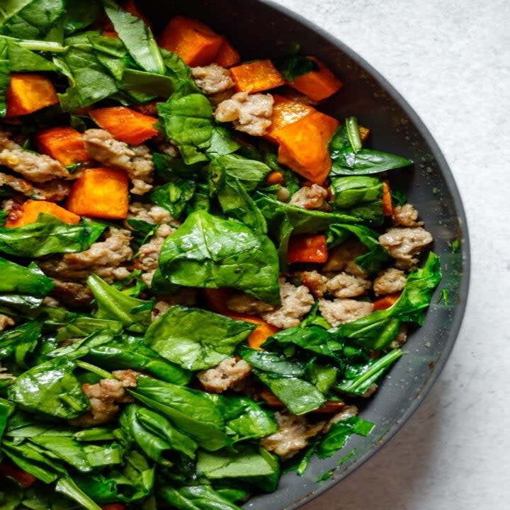 Spinach, sausage, and sweet potato in a skillet