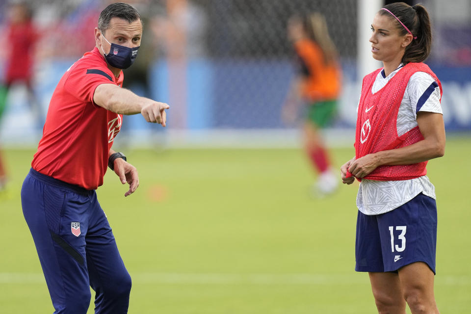 United States women's national soccer team coach Vlatko Andonovski, left, talks with Alex Morgan, right, before a friendly soccer match against Portugal Thursday, June 10, 2021, in Houston. (AP Photo/David J. Phillip)