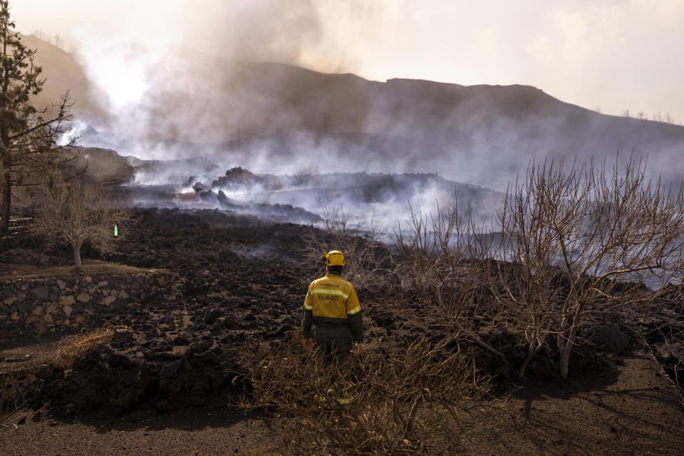 Ash and debris after an eruption of a volcano near El Paso on the island of La Palma in the Canaries, Spain, Tuesday, Sept. 21, 2021. A dormant volcano on a small Spanish island in the Atlantic Ocean erupted on Sunday, forcing the evacuation of thousands of people. Huge plumes of black-and-white smoke shot out from a volcanic ridge where scientists had been monitoring the accumulation of molten lava below the surface. (AP Photo/Emilio Morenatti)