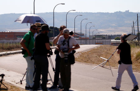 Journalists wait outside the prison where two of the five men cleared of gang rape of a teenager and convicted of a lesser crime of sexual abuse are due to leave jail after being granted provisional release in Alcala de Henares, near Madrid, Spain, June 22, 2018. REUTERS/Javier Barbancho