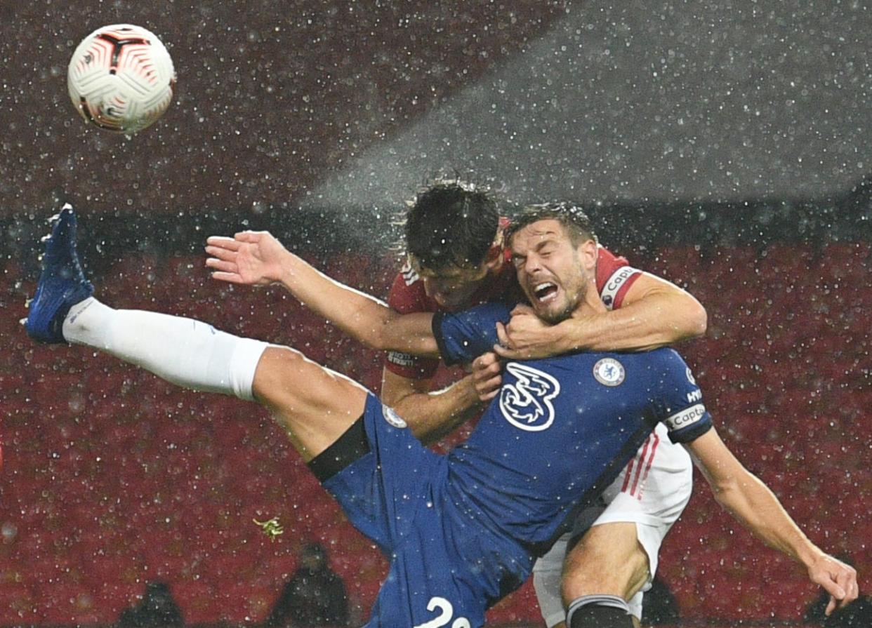 Manchester United defender Harry Maguire challenges Cesar Azpilicueta (POOL/AFP via Getty Images)