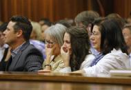 Aimee Pistorius (2nd R), sister of South African Olympic and Paralympic sprinter Oscar Pistorius cries as he gives evidence during his trial at the high court in Pretoria April 8, 2014. REUTERS/Kim Ludbrook/Pool