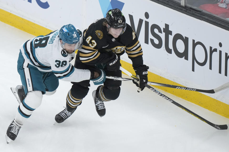 San Jose Sharks defenseman Mario Ferraro (38) grapples for position with Boston Bruins left wing Danton Heinen in the first period of an NHL hockey game, Thursday, Nov. 30, 2023, in Boston. (AP Photo/Steven Senne)