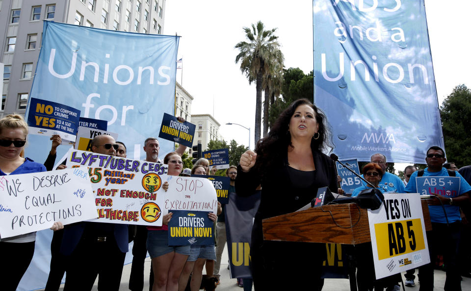 In this Aug. 28, 2019, photo, Assemblywoman Lorena Gonzalez, D-San Diego, speaks at rally calling for passage of her measure to limit when companies can label workers as independent contractors at the Capitol in Sacramento, Calif. California lawmakers are debating a bill that would make companies like Uber and Lyft label their workers as employees, entitling them to minimum wage and benefits. (AP Photo/Rich Pedroncelli, File)