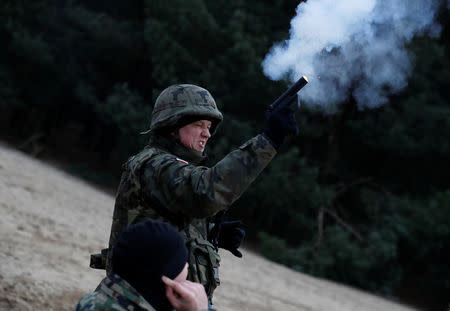 A recruit fires a flare gun during his 16-day basic training for Poland's Territorial Defence Forces, at a shooting range near Siedlce, Poland, December 7, 2017. REUTERS/Kacper Pempel/Files