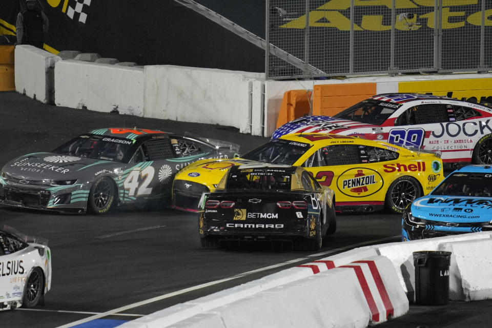 NASCAR Cup Series driver Kyle Busch, center, gets turned around during a NASCAR exhibition auto race at Los Angeles Memorial Coliseum, Sunday, Feb. 5, 2023, in Los Angeles. (AP Photo/Ashley Landis)