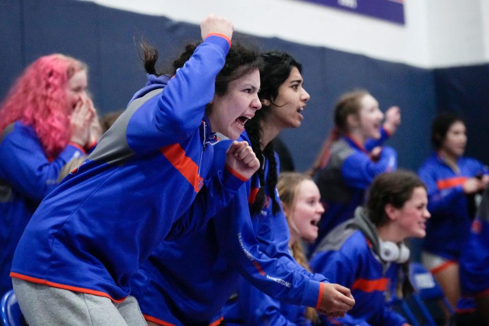 Olentangy Orange’s Lexi Riley, left, cheers on teammate Jenny Huaracha-Arellanos during the girls wrestling state duals Sunday at Marysville.