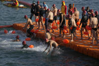 Competitors swim during a harbor race at the Victoria Harbor in Hong Kong, Sunday, Dec. 12, 2021. Hundreds of people took part in traditional swim across iconic Victoria Harbor after two years of suspension. (AP Photo/Kin Cheung)