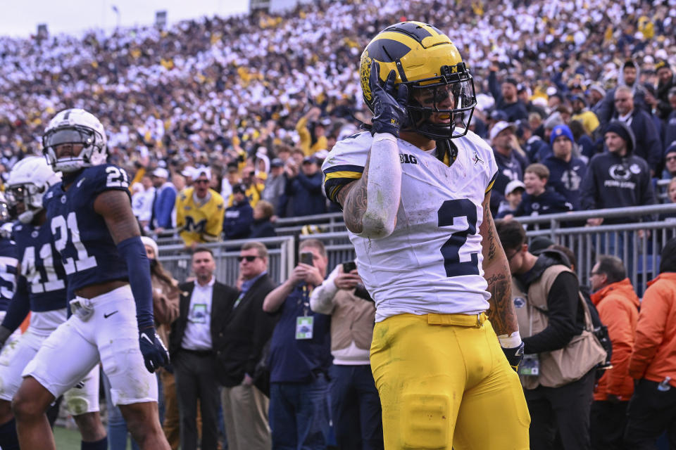 Michigan running back Blake Corum (2) celebrates a touchdown in front of Penn State safety Kevin Winston Jr. (21) during the second half of an NCAA college football game, Saturday, Nov. 11, 2023, in State College, Pa. (AP Photo/Barry Reeger)