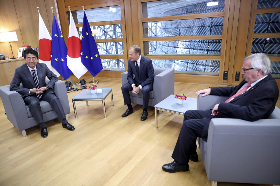 Japan's Prime Minister Shinzo Abe, left, meets with European Commission President Jean-Claude Juncker, right, and European Council President Donald Tusk, center, during an EU-Japan summit at the European Council building in Brussels, Thursday, April 25, 2019. Japanese Prime Minister Shinzo Abe and top EU officials are discussing trade, bilateral ties and North Korea. (AP Photo/Francisco Seco, Pool)