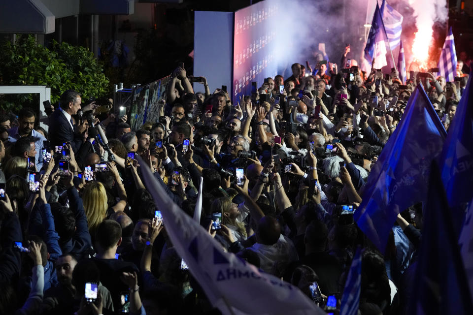 Greece's Prime Minister and leader of New Democracy Kyriakos Mitsotakis, top left, addresses supporters at the headquarters of his party in Athens, Greece, Sunday, May 21, 2023. The conservative party of Greek Prime Minister Kyriakos Mitsotakis has won a landslide election but without enough parliamentary seats to form a government. (AP Photo/Thanassis Stavrakis)