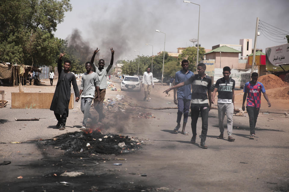 People burn tires during a protest a day after the military seized power Khartoum, Sudan, Tuesday, Oct. 26, 2021. The takeover came after weeks of mounting tensions between military and civilian leaders over the course and the pace of Sudan's transition to democracy. (AP Photo/Marwan Ali)