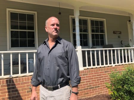 Gerald Bostock, who says he lost his job because he is gay, poses outside his home in Atlanta