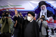 Ebrahim Raisi, head of Iran's judiciary waves to media as he attends at the Interior Ministry to register his candidacy for the June 18 presidential elections at the elections headquarters of the Interior Ministry in Tehran, Iran, Saturday, May 15, 2021. (AP Photo/Ebrahim Noroozi)